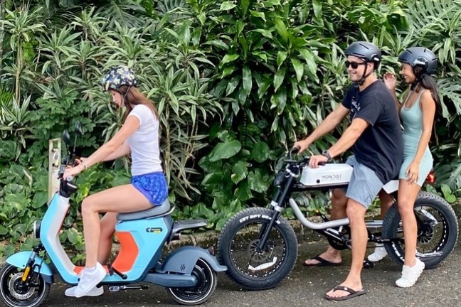 a group of people riding on the back of a motorcycle